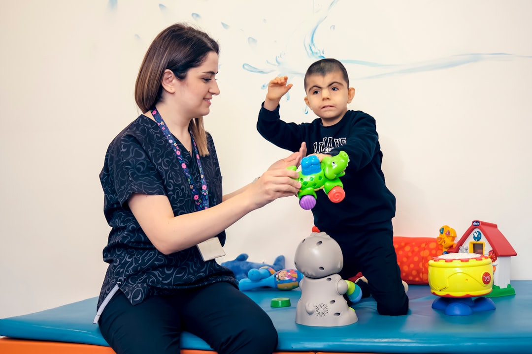 A child with Cornelia de Lange Syndrome spends time in the physiotherapy room with the nurse